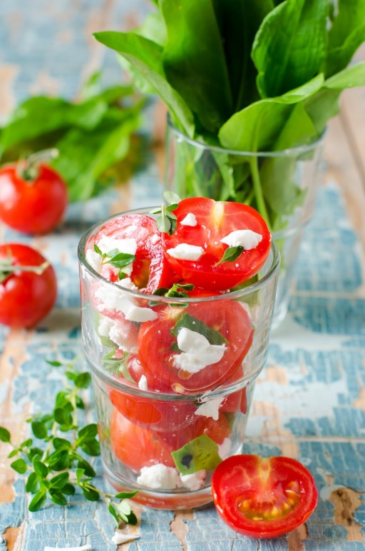 Salad of fresh cherry tomatoes with herbs and cheese